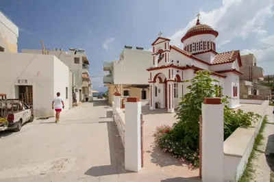 a person walking down a street next to a building at Kissamia - Self Check In Only - Next to Night Clubs in Kissamos