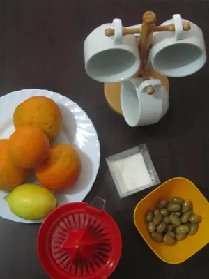 a table with a plate of fruit and a bowl of nuts at Economy Studio Apartments in Chania Town