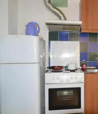a kitchen with a white stove and a refrigerator at Economy Studio Apartments in Chania Town