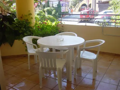 a white table and chairs in front of a window at Marias Studios & Apartments in Platanias in Plataniás