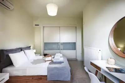 a bedroom with a bed and a table and a mirror at Dream Villa in Kambánion