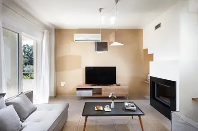 a living room with a couch and a tv at Dream Villa in Kambánion