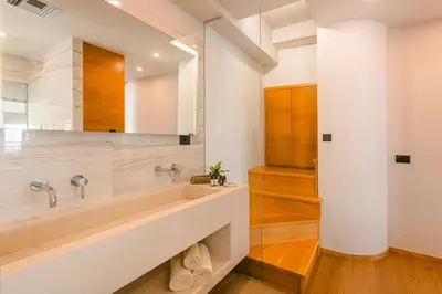 a bathroom with a tub and a sink at Querini Luxury Suites in Chania Town