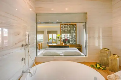 a bathroom with a large mirror and a bath tub at Querini Luxury Suites in Chania Town