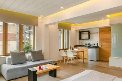 a living room with a couch and a kitchen at Querini Luxury Suites in Chania Town