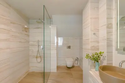 a bathroom with a shower and a sink and a toilet at Querini Luxury Suites in Chania Town