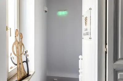 a hallway with a door with a statue next to it at Casa Kallergi in Chania Town