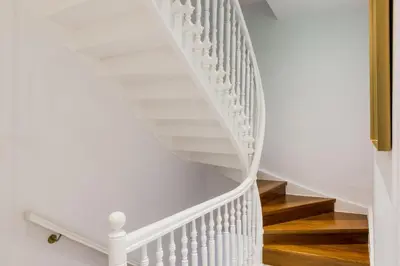 a white spiral staircase with wooden floors at Casa Kallergi in Chania Town