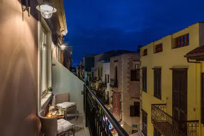 a balcony with a view of a city at night at Casa Kallergi in Chania Town