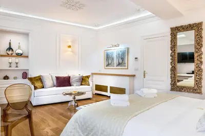 a white room with two beds and a couch at Casa Kallergi in Chania Town
