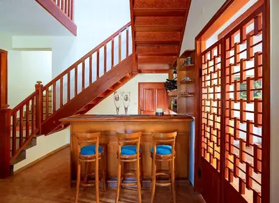 a kitchen with a bar with two wine glasses at Villa Mare in Tersanas