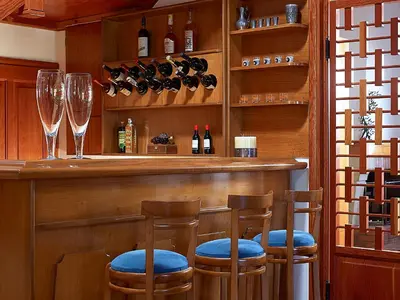 a bar with four chairs and wine glasses at Villa Mare in Tersanas