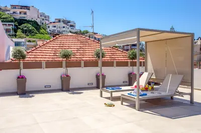 a patio with a canopy on a roof at Angels Suites in Plataniás