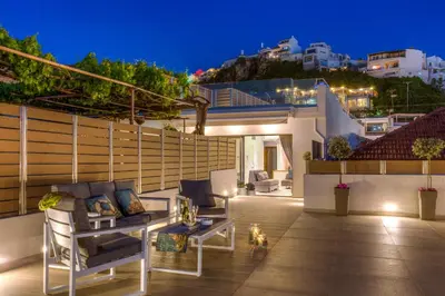 a patio with a couch and a table on a building at Angels Suites in Plataniás