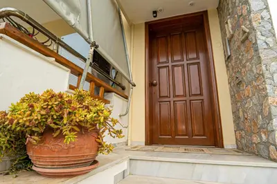 a door of a house with a potted plant at Contemporary 2 bedroom apt 5 min walk from Kissamos center in Kissamos