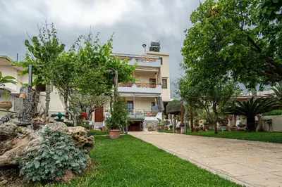 a large white building with trees in front of it at Contemporary 2 bedroom apt 5 min walk from Kissamos center in Kissamos