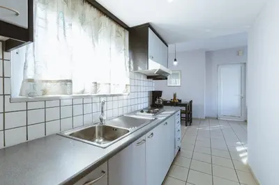 a kitchen with a sink and a window at Gelina Apartments in Plataniás