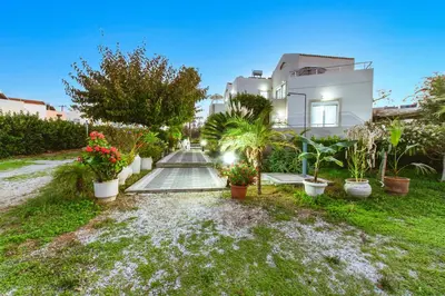 a house with plants in front of it at Gelina Apartments in Plataniás