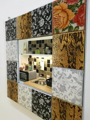 a kitchen with black and white tiles on the wall at City Square Apartment in Chania Town