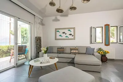 a living room with a couch and a table at Big Blue Villa in Kisamos, 10 meters from Sea in Kissamos