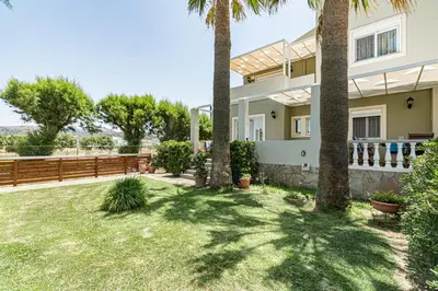 a house with palm trees in the yard at Big Blue Villa in Kisamos, 10 meters from Sea in Kissamos