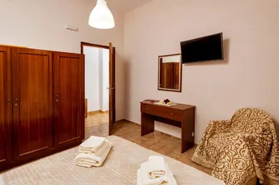 a room with a bed and a chair and a desk at Falassarna House in Plátanos