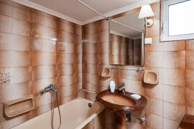 a bathroom with a sink and a bath tub at Falassarna House in Plátanos