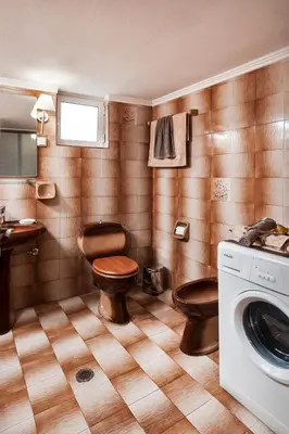 a bathroom with two toilets and a washing machine at Falassarna House in Plátanos