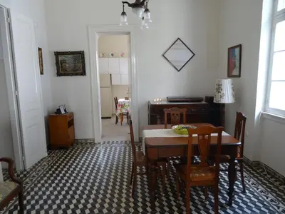 a dining room with a table and chairs and a desk at Neoclassical House in Chania Town