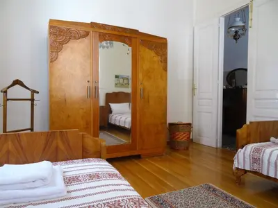 a room with a large wooden cabinet with a mirror at Neoclassical House in Chania Town