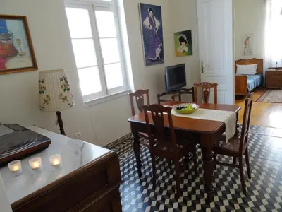 a living room with a dining room table and a table and chairs at Neoclassical House in Chania Town