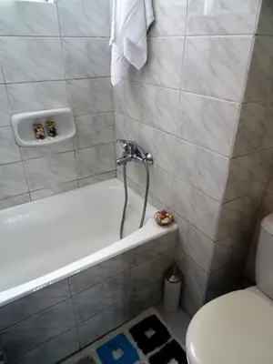 a bathroom with a white tub and a toilet at Neoclassical House in Chania Town