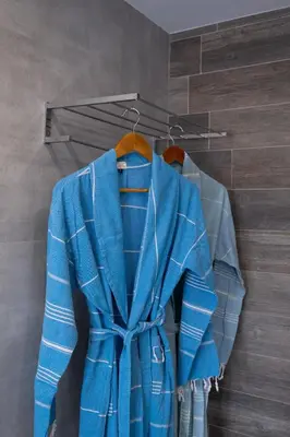 a blue jacket and a shirt on a hanger at Glaros Casa Verde - Cozy flat with Garden near Beach in Kato Daratso