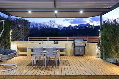 a patio with a table and chairs and a grill at Glaros Casa Verde - Cozy flat with Garden near Beach in Kato Daratso
