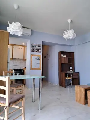 a dining room and kitchen with a table and chairs at Nais Apartments & Studios in Chania Town