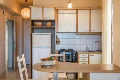 a kitchen with a table and a refrigerator at Nais Apartments & Studios in Chania Town