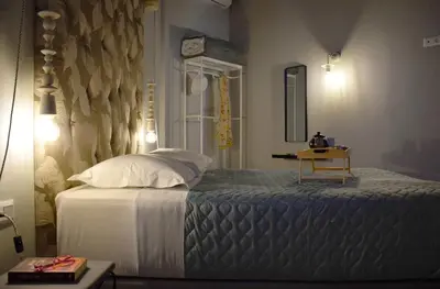 a bedroom with a bed with a clock on the wall at Evaris Apartments in Chania Town