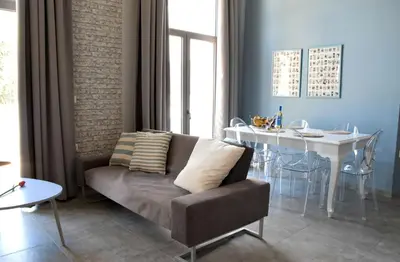 a living room with a couch and a table at Evaris Apartments in Chania Town