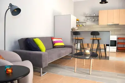 a living room with a couch and a kitchen at Evaris Apartments in Chania Town