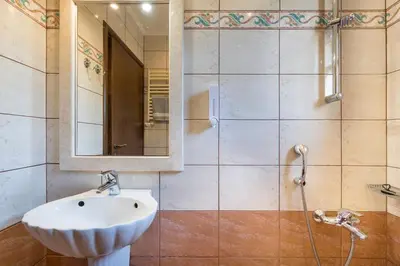 a bathroom with a sink and a mirror at Adam Villas in Falasarna
