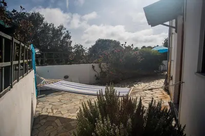 a hammock in a yard next to a fence at Villa Afou in Afráta