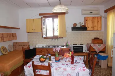 a kitchen with a table with fruit on it at Tasos Cottages in Gerani Chanion