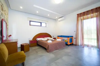a bedroom with a bed and a play table at Iridanos Villa in Kissamos