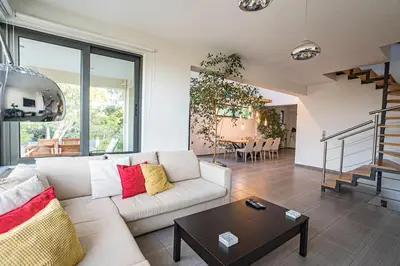 a living room with a white couch and a table at Villa Detoro in Kambánion
