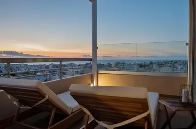a balcony with two chairs and a view of a city at Urban 35 in Chania Town
