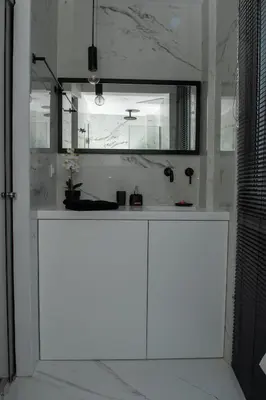 a white bathroom with a sink and a mirror at Urban 35 in Chania Town