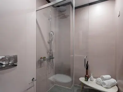 a bathroom with a shower with a toilet and a sink at Elia Palatino Hotel in Chania Town