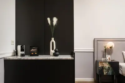 a white vase with flowers in it on a counter at Elia Palatino Hotel in Chania Town