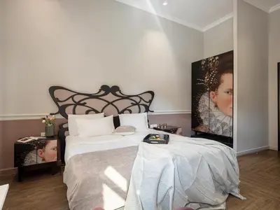 a bedroom with a large bed with white sheets at Elia Palatino Hotel in Chania Town