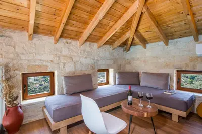 a living room with a couch and a table at Villa Kourouni in Stalos